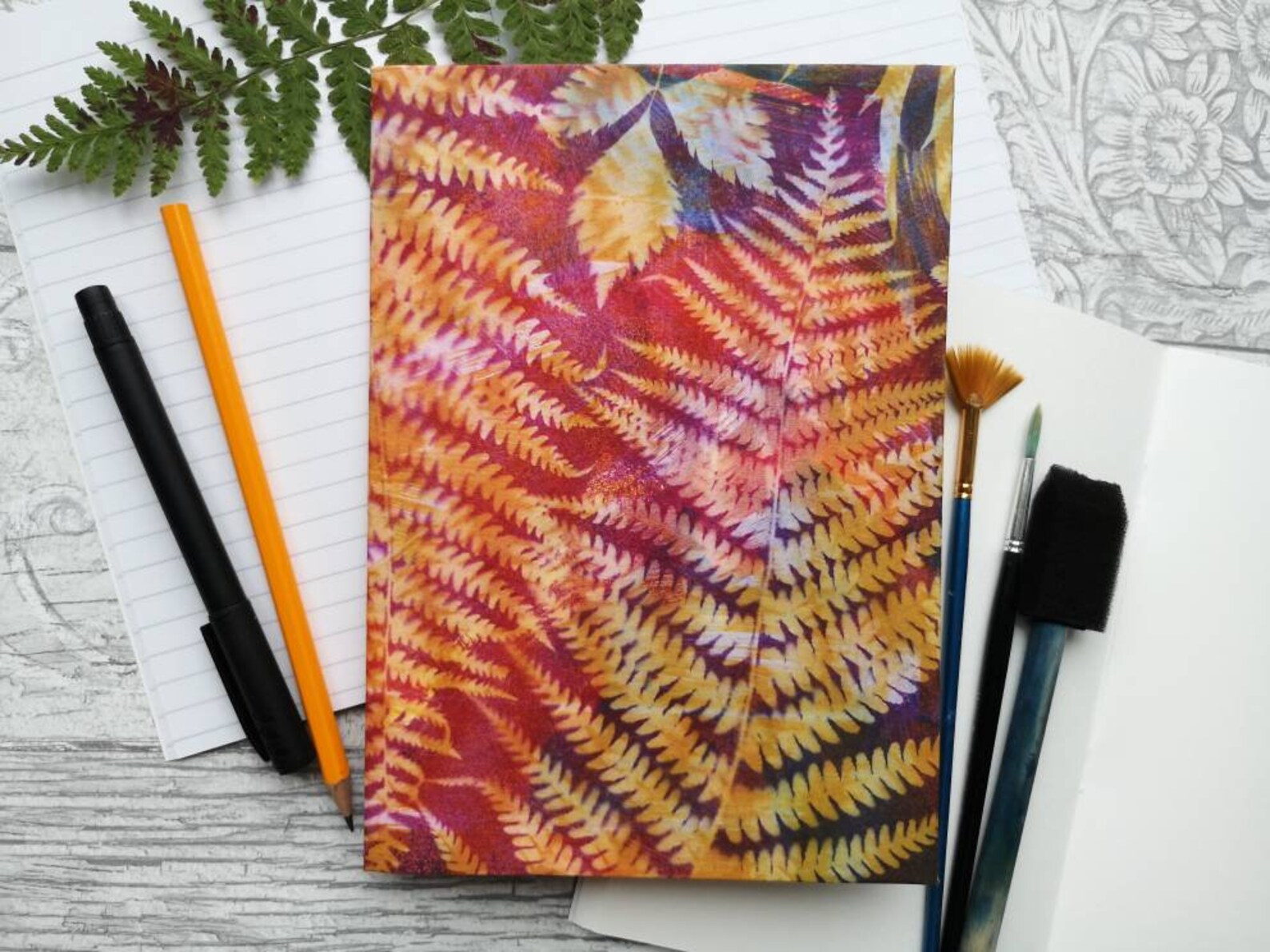 Warm fern notebook flatlay